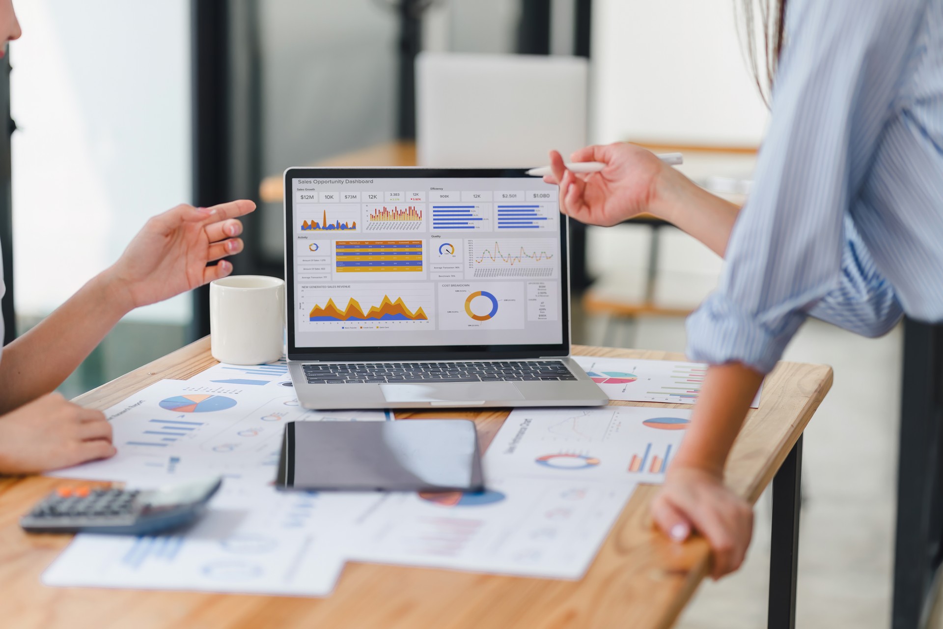 Two data analysts Working on data analysis dashboard for business strategy.